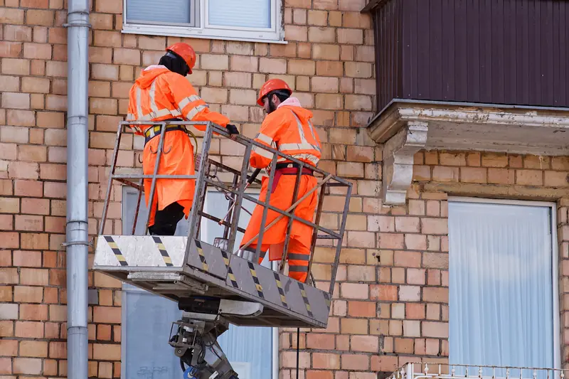 Crew pressure washing a building exterior
